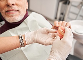 a dentist and patient chatting about dentures