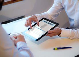 An insurance agent discussing dental insurance with a patient