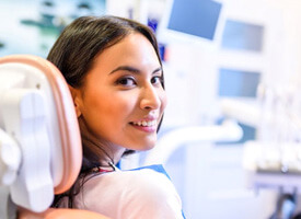 happy female dental patient looking over her shoulder