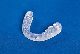 Custom nightguards for bruxism in Pittsburgh against blue background