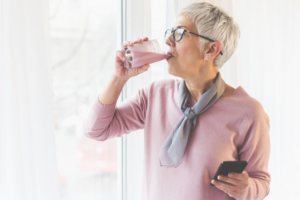 Older woman enjoying a strawberry smoothie